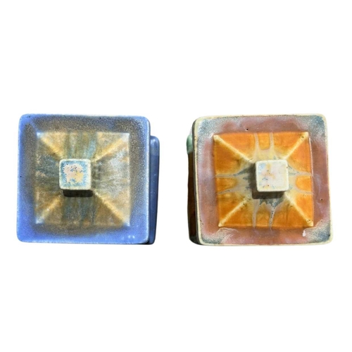 165 - Two Ruskin Pottery square form crystaline glazed biscuit barrels, marks to base, 18cm high (2)... 