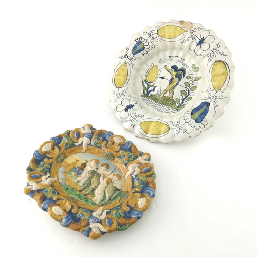 226 - A majolica polychrome plate, circa 18th century, lobed ogee form, moulded with putti playing with a ... 