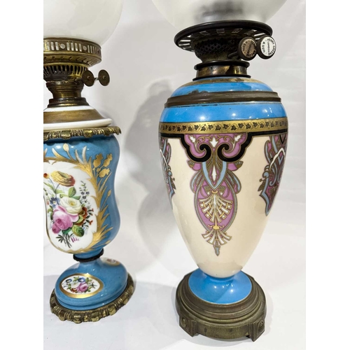 227 - Two oil lamps: Henry Greene & Son of London, ceramic body decorated in the manner of Zsolnay Pec... 