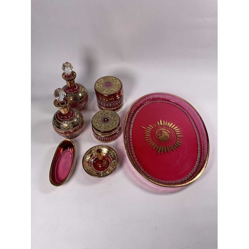 251 - WITHDRAWN
A pink glass gilded dressing table set with tubelined enamel floral decoration, oval tray ... 