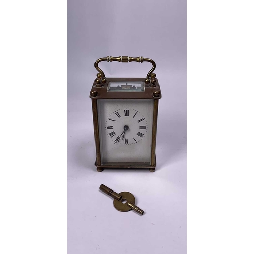 307 - A travel/carriage clock, Roman numeral dial, 10cm high, with original leather and velvet covered cas... 