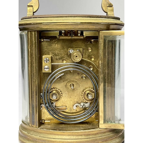 309 - A French carriage clock, early 20th Century, oval brass corniche case with visible escapement, white... 