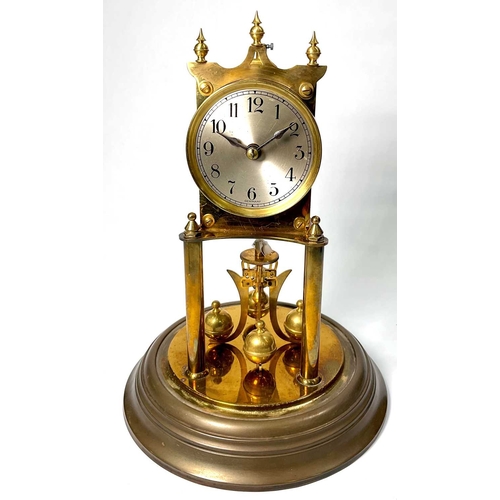 311 - A German brass weight-driven timepiece, 20th Century, silvered dial, under a glass dome, 27cm high... 