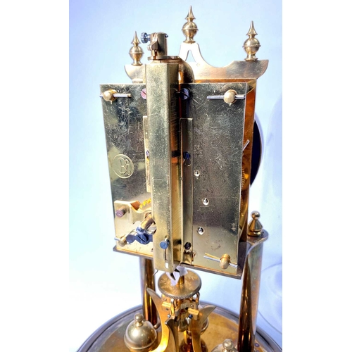 311 - A German brass weight-driven timepiece, 20th Century, silvered dial, under a glass dome, 27cm high... 