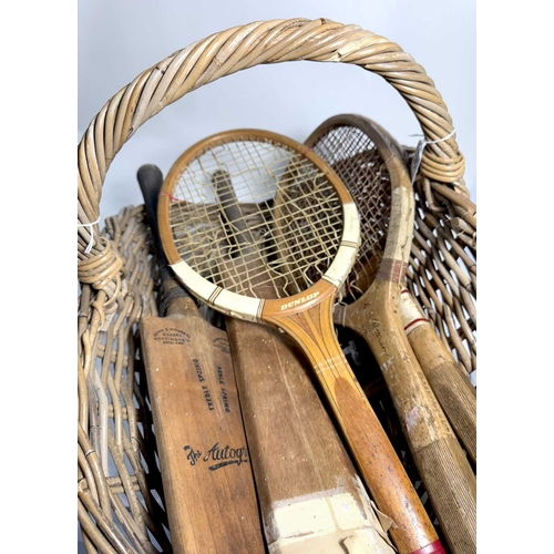 341 - A 1915 wicker flower cutters basket with a collection of early to mid 20th century tennis rackets an... 