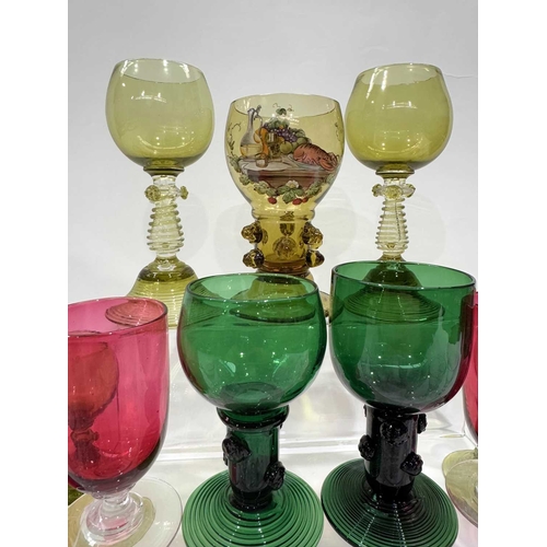 52 - A collection of green glass Germanic rummers with printed and trailed baluster stems and feet, ename... 