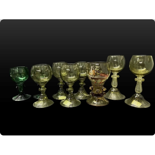 52 - A collection of green glass Germanic rummers with printed and trailed baluster stems and feet, ename... 