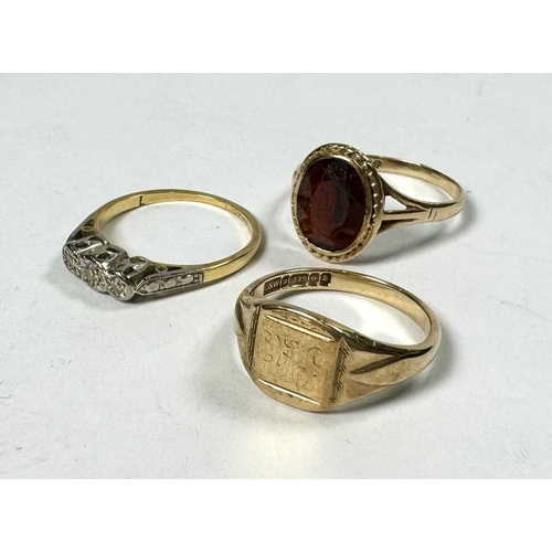 573 - Three gold rings, to include an 18ct gold diamond three-stone ring, all with hallmarks, ring sizes K... 