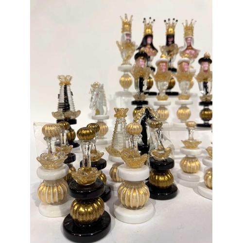 59 - A Murano glass chess set, figurative pieces worked in clear, white, black and gold foil-infused glas... 