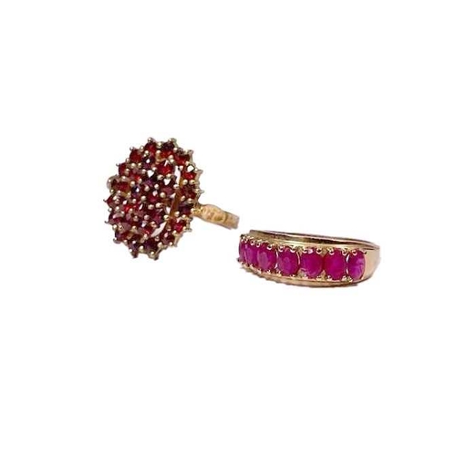 607 - A gold coloured metal oval-shape ruby half eternity ring, together with a silver gilt garnet cluster... 