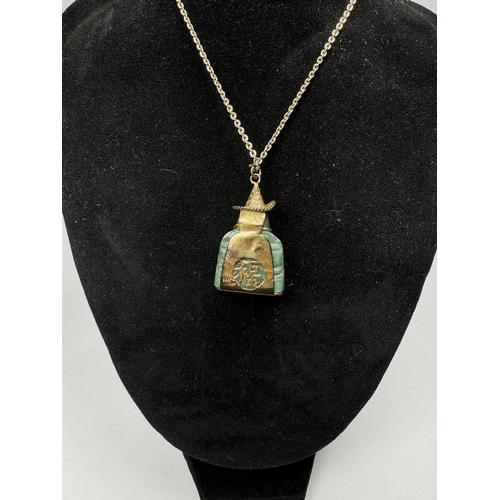 636 - A carved aventurine quartz Buddha pendant, with trace-link chain, pendant stamped 14k, length of pen... 