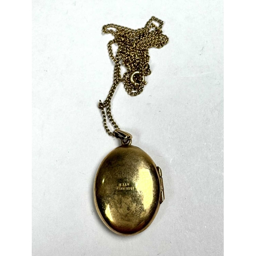 638 - A 9ct gold engraved locket pendant, suspended from a 9ct gold chain, pendant with hallmarks for 9ct ... 