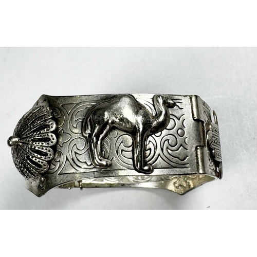 673 - An early 20th century silver camel and hamsa bangle bracelet, inner diameter 6cm, 51.7g