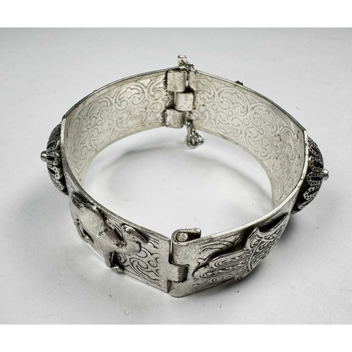 673 - An early 20th century silver camel and hamsa bangle bracelet, inner diameter 6cm, 51.7g