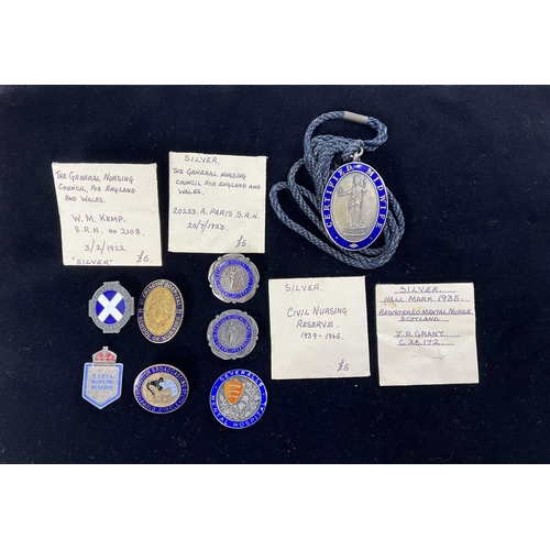 695 - A collection of enamelled silver and base metal nursing badges and medals including 'Registered Ment... 