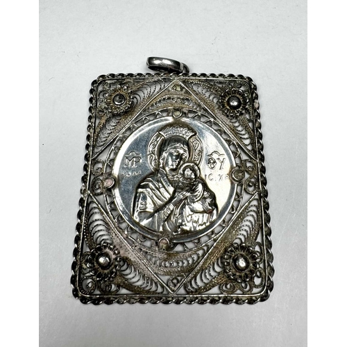 725 - A large white metal repoussé and filigree crowned Virgin and Child Icon rectangular pendant, 24g, bo... 