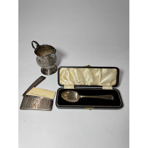 742 - A George V silver rectangular card case, hallmarked Birmingham 1924, together with a cream jug, and ... 