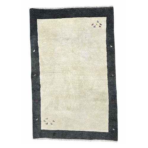 762 - A Gabbeh wool rug, green and cream hues, 280cm by 180cm