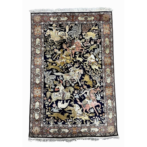 766 - A silk rug depicting a field of mounted huntsman and an array of animals within a typically Persian ... 