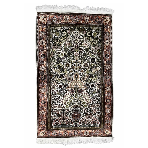 769 - A silk, possibly Turkish prayer mat rug, floral border surrounding a scene of birds, flowers and fol... 