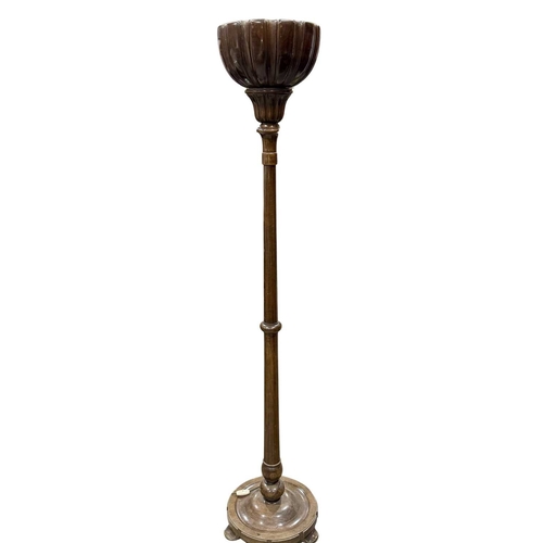 784 - A large mahogany standard floor lamp, gadrooned bowl form atop a turned column on a circular three-f... 