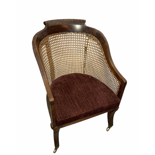 789 - A Regency bergere armchair with red covered squab cushion, multi convex reeding to edges on saber le... 