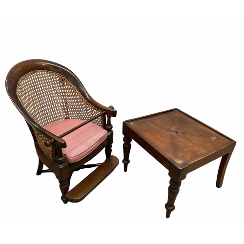 790 - A 19th century mahogany child's bergere armchair, detachable from the associated table, 91cm high... 