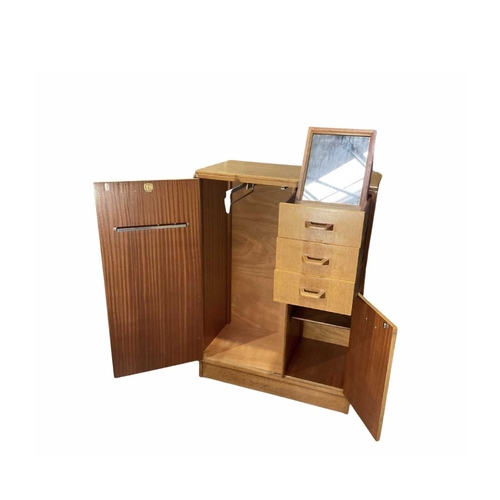 807 - An oak G-Plan tallboy, mid-century, three short drawers, top drawer with pullout mirror, above cupbo... 