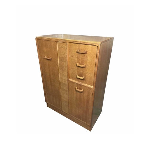 807 - An oak G-Plan tallboy, mid-century, three short drawers, top drawer with pullout mirror, above cupbo... 