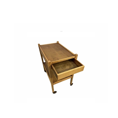 810 - A teak serving trolley, 68cm high, 61cm wide, 38cm deep together with an upholstered oak piano stool... 