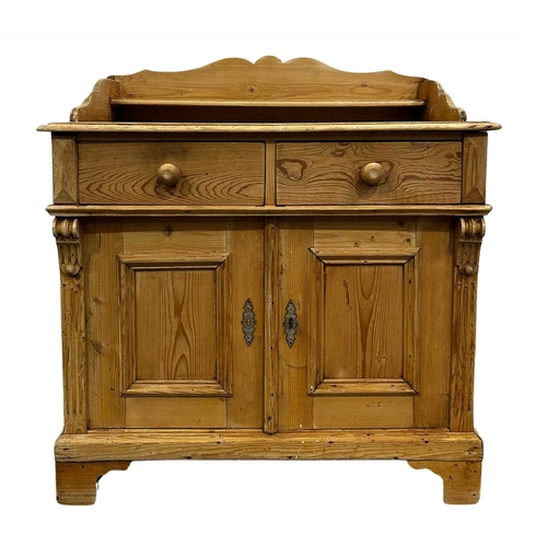 826 - A traditional stripped pine wash stand, raised serpentine back with integral shelf, twin frieze draw... 