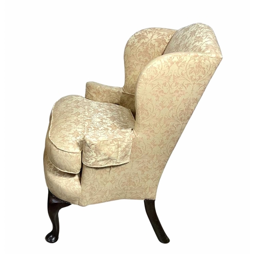 841 - A good quality wingback armchair in the Queen Ann style, 19th century or earlier, on cabriole legs d... 