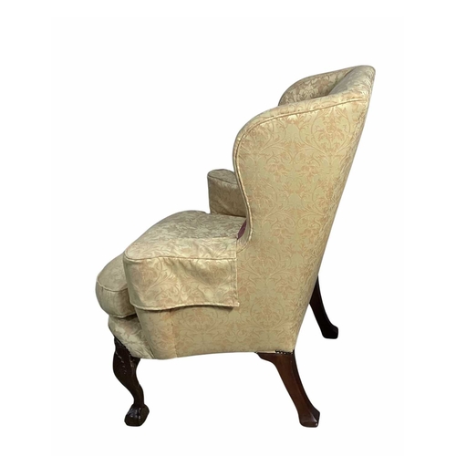 842 - A late 19th/early wingback armchair in the George II style, cabriole legs carved with a shell knee t... 