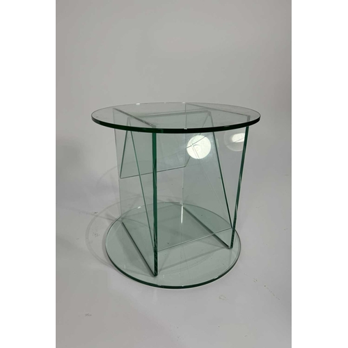 848 - A Greenapple Co. glass contemporary circular table, sloped glass panels forming the magazine rack, 4... 