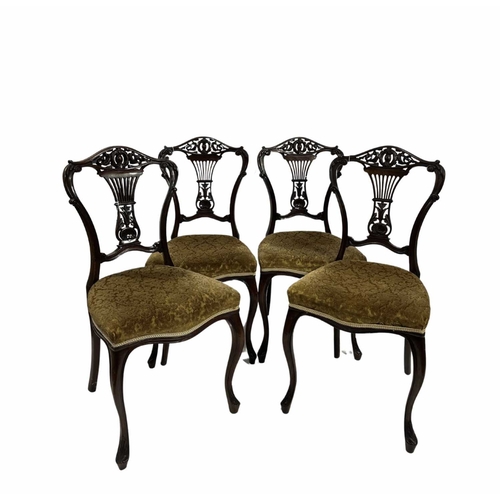 850 - A set of four Edwardian mahogany dining chairs, ornately carved splats on cabriole legs with yellow ... 