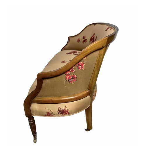 852 - Small mahogany framed salon sofa, possibly French, reeded legs on brass casters, covered in a floral... 