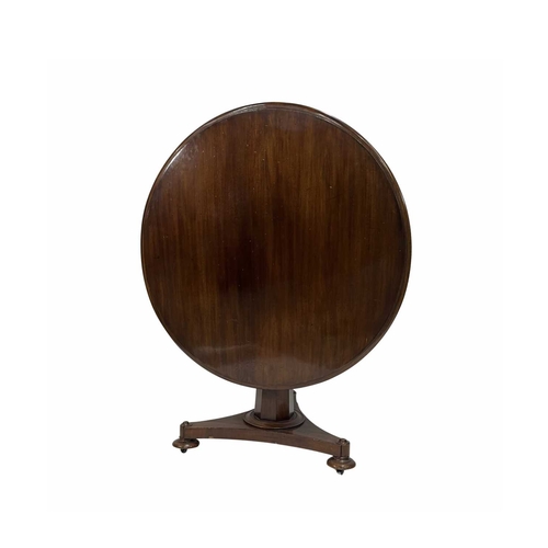 861 - A 19th century round tilt top breakfast or dining table, mahogany on tapered faceted column, top cas... 