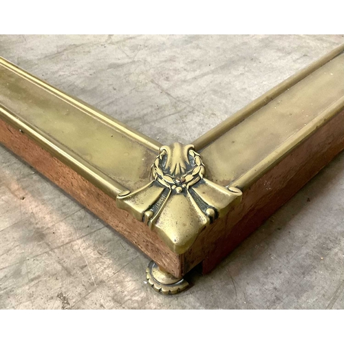 873 - A late victorian brass fire curb, centred by leaf scrolls and a cartouche, the sides with hammered c... 