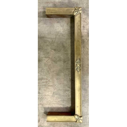 873 - A late victorian brass fire curb, centred by leaf scrolls and a cartouche, the sides with hammered c... 