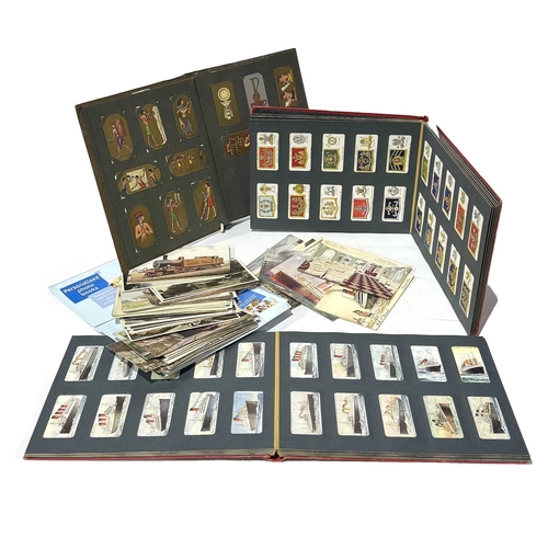 89 - A collection of early 20th century postcards, photographs and Wills's cigarette card albums relating... 