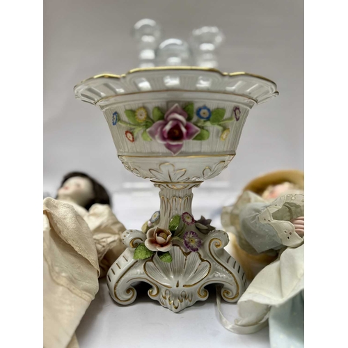 91 - Three cut glass decanters with mushroom stoppers, two hand painted china dolls and a floral encruste... 