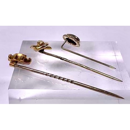 580 - Three 19th century diamond stickpins, one stamped 9ct, one stamped 18ct, length of stickpin heads 1.... 