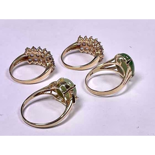 599 - Two gold coloured metal jadeite cabochon dress rings, together with two gold coloured metal amethyst... 