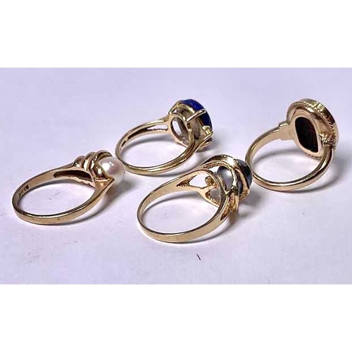 606 - Four gold coloured metal gem-set rings, to include a lapis lazuli and an onyx cabochon single-stone ... 