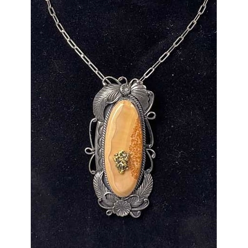 637 - An American Navajo silver banded agate foliate pendant, with gold nugget overlay, signed Thomas J, s... 