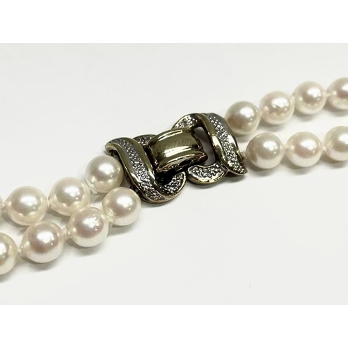 650 - A cultured pearl two-row necklace, with gold coloured metal clasp, stamped 375, wearable length 62cm... 