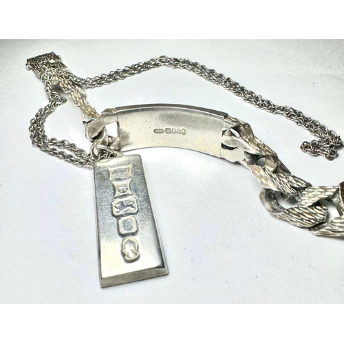 668 - A silver ingot pendant on chain and a silver heavy gauge curb bracelet with textured links