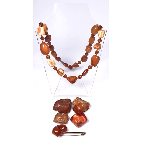 682 - A selection of amber items, to include a bead necklace, loose amber and a brooch, total weight appro... 