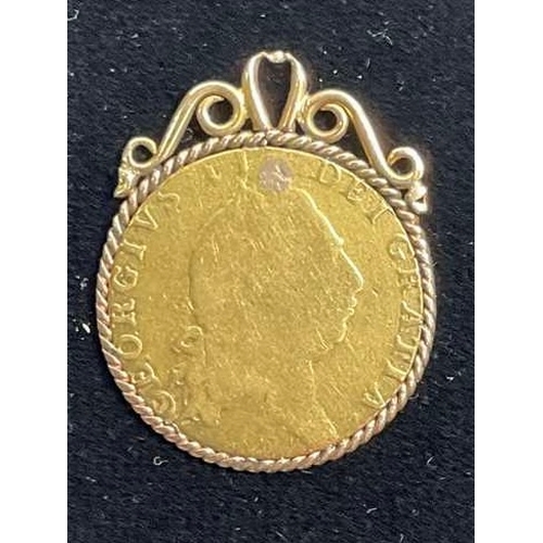 696 - George II, a gold Guinea coin, dated 1793, mounted as a gold coloured metal pendant, with rope-twist... 