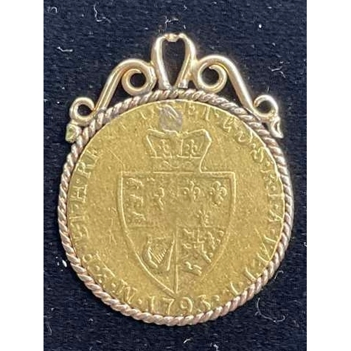 696 - George II, a gold Guinea coin, dated 1793, mounted as a gold coloured metal pendant, with rope-twist... 